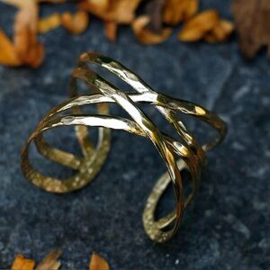 Criss-Cross cuff bracelet adds an effortless accent to any outfit.